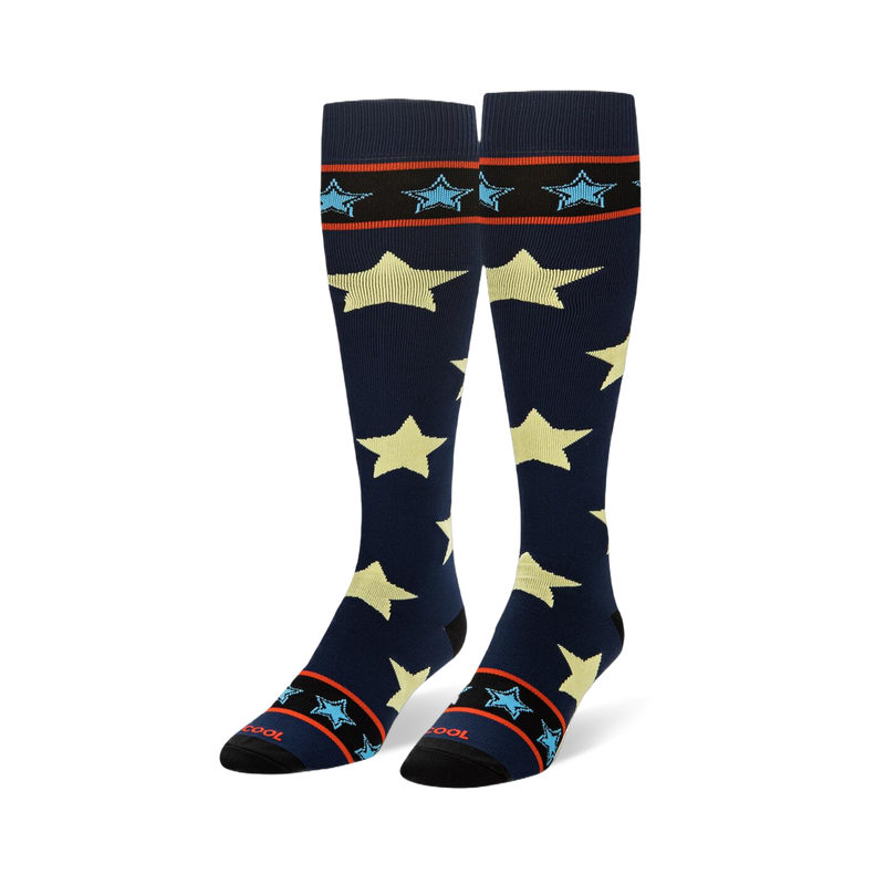 Tall navy blue socks showing large pale yellow stars and striped black cuffs with small light blue stars.