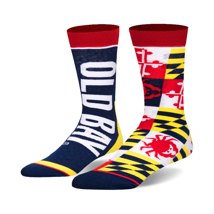 Pair of Old Bay Split crew socks. One sock displays the 'Old Bay' logo in white against a navy blue background. The other sock features a patchwork design of the Maryland state flag, incorporating red, white, yellow, and a crab. }}