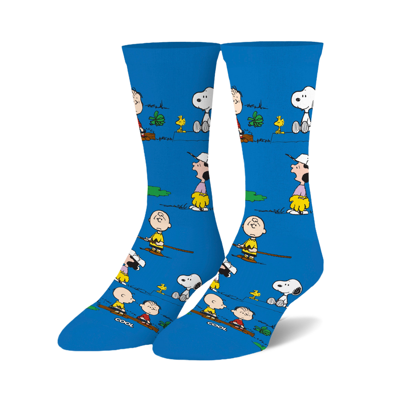 Crew socks in bright blue featuring Peanuts characters like Snoopy and Charlie Brown engaged in outdoor activities.