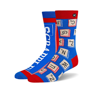 Pair of blue and red crew socks. One sock features Scrabble tiles, the other the Scrabble logo. Fun and geeky!