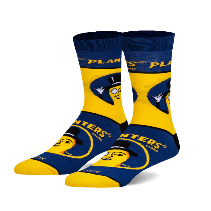 A pair of crew socks in yellow and navy blue. The design features Mr. Peanut, the Planters mascot, wearing a top hat and monocle. }}