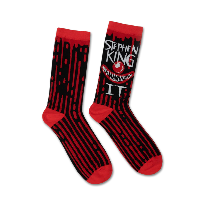 Pair of black and red crew socks. A grinning Pennywise clown face and 'Stephen King IT' text are featured on one side. Dripping blood design accents the stripes. }}