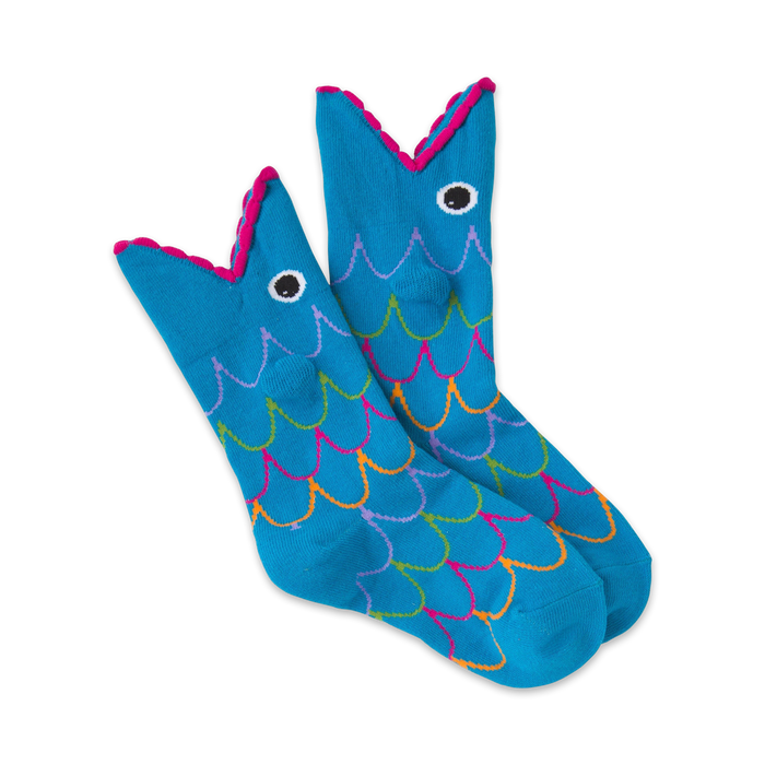 A pair of blue crew socks with a whimsical fish design. The fish have pink mouths and colorful scales.