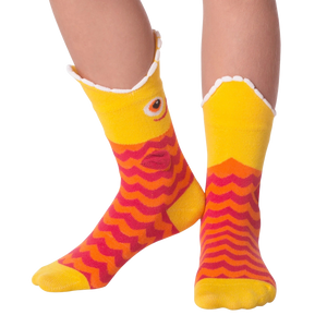 A pair of yellow socks with a fish-shaped top and red and orange wave-patterned body.