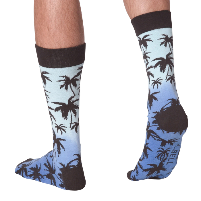 Back view of Palm Socks on a person's legs against a black background.