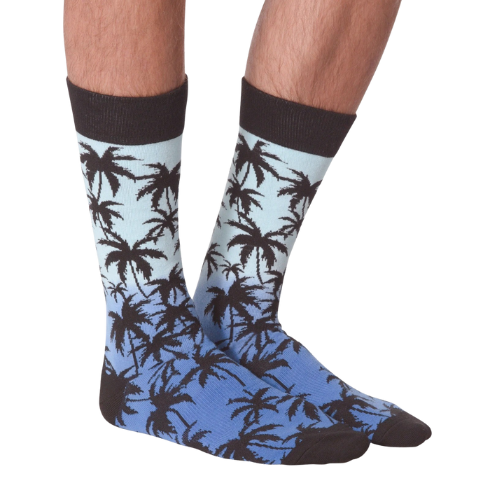 Front view of Palm Socks on a person's legs against a black background.