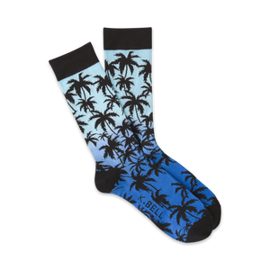 Pair of crew socks with a blue and black ombre gradient and silhouette palm tree design.