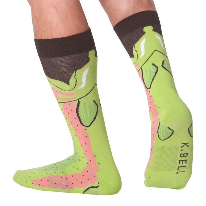 A pair of green socks with a pattern of cartoon rainbow trout wearing top hats.