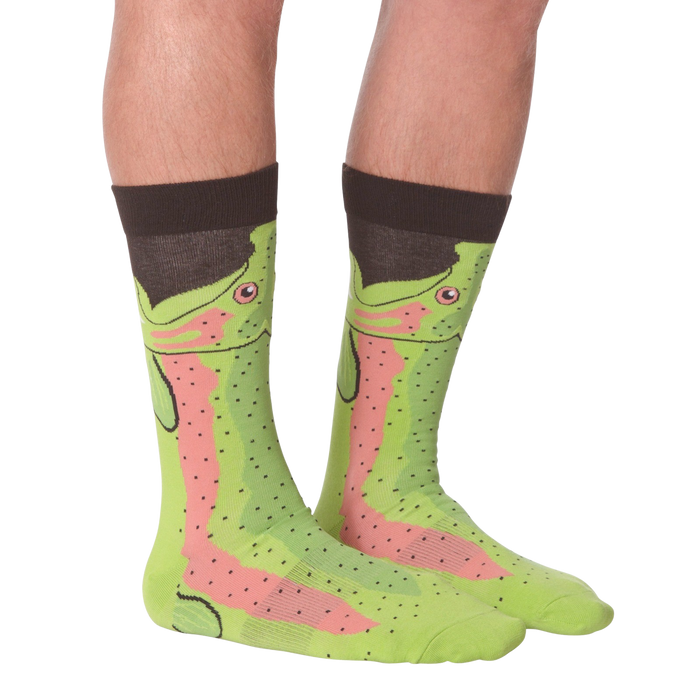 A pair of green socks with a pattern of cartoon rainbow trout wearing top hats.