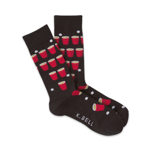 Pair of black crew socks with a fun beer pong design. Red solo cups and white ping pong balls are scattered on the dark fabric.