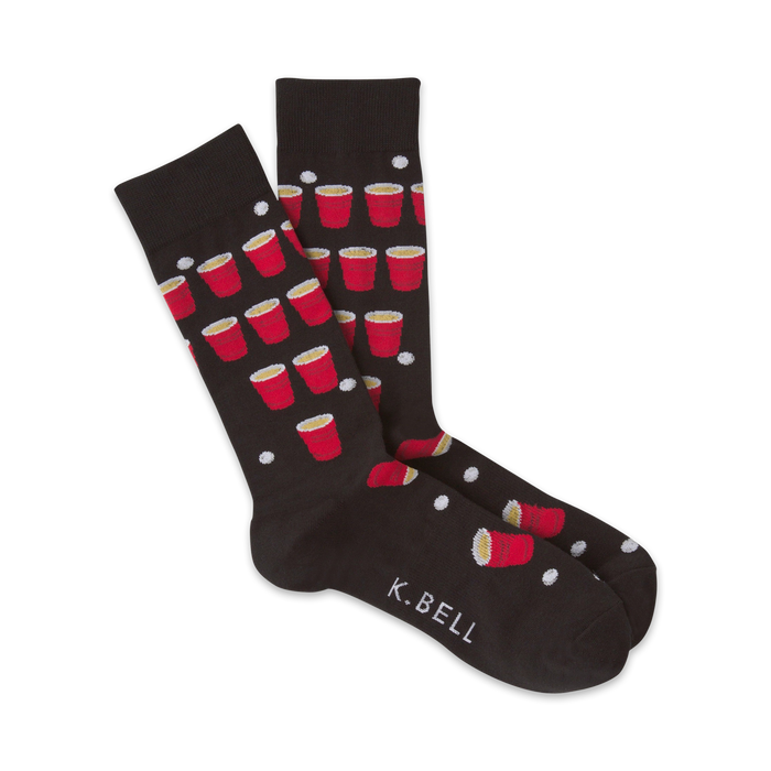 Pair of black crew socks with a fun beer pong design. Red solo cups and white ping pong balls are scattered on the dark fabric.