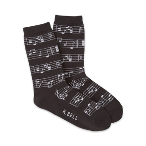 Pair of crew socks in dark grey and white with a musical notes design.  The socks show a repeating pattern of musical notes on a staff.