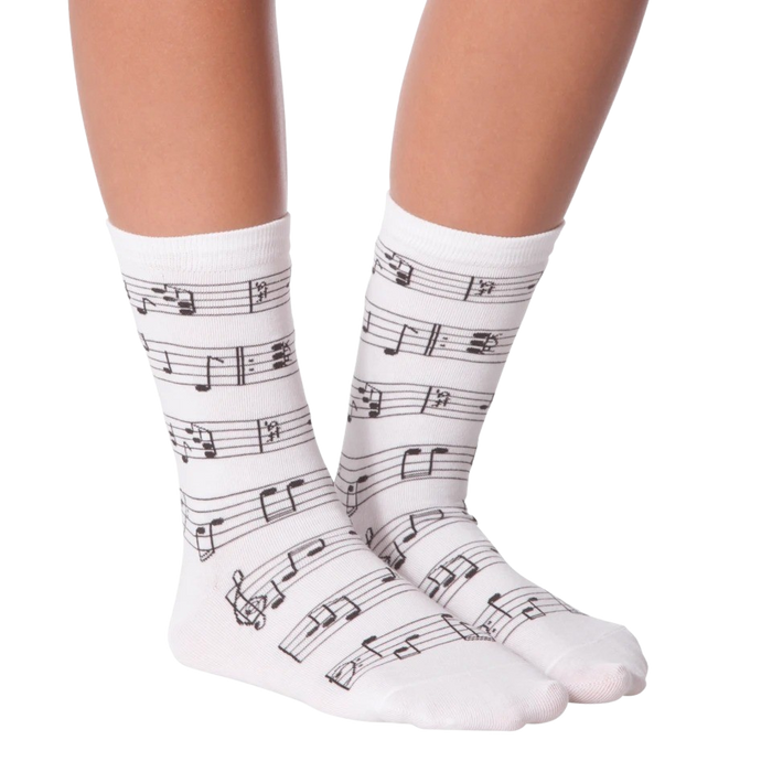 Lifestyle shot of model wearing white musical note socks.