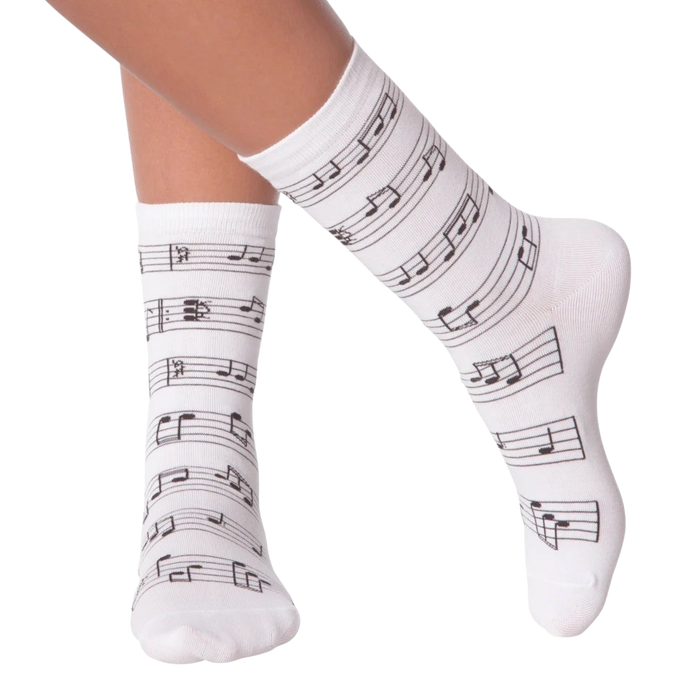 Close up of a person's legs wearing white musical note socks.