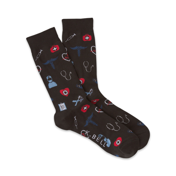 A pair of dark gray crew socks with a pattern of red and blue medical icons like syringes, hearts, and stethoscopes. }}