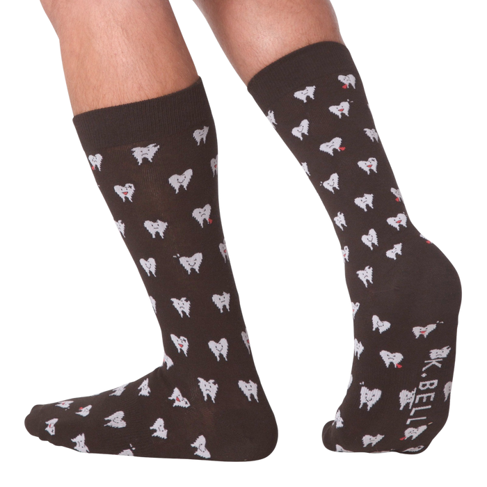 Lifestyle shot showing the socks on a person's feet.  The socks are dark brown with a tooth pattern. The image is on a black background.