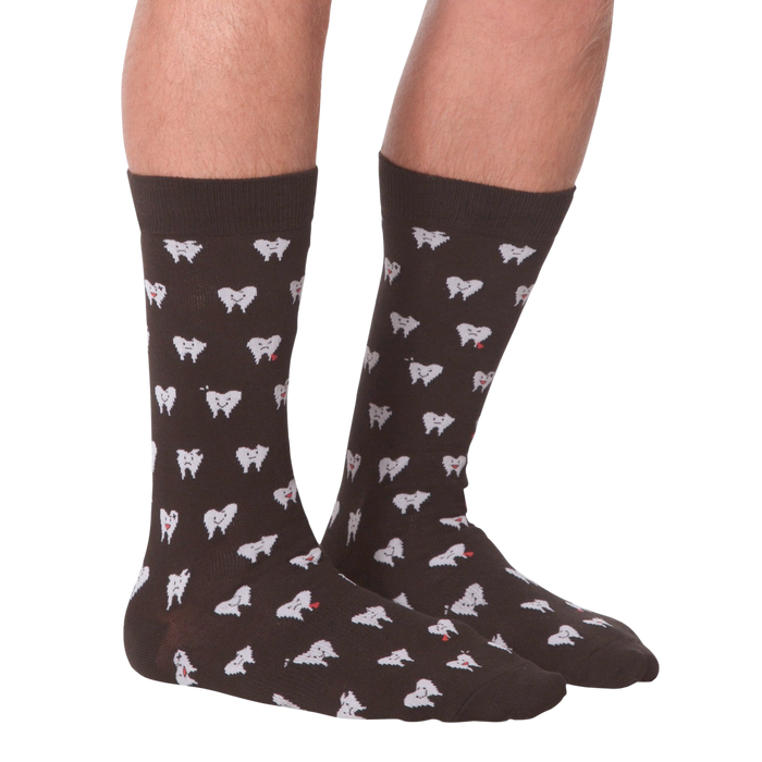Another lifestyle shot showing the socks on a person's feet, this time from the front.  The socks are dark brown with a tooth pattern. The image is on a black background.