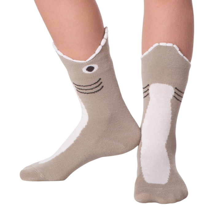 A pair of socks decorated with a shark face. The socks are mostly light gray with a white belly and a dark gray fin. The shark face has black eyes and a black mouth.