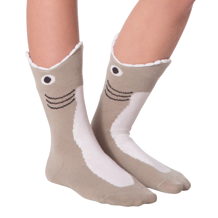 A pair of socks decorated with a shark face. The socks are mostly light gray with a white belly and a dark gray fin. The shark face has black eyes and a black mouth.