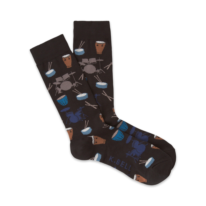 Pair of dark brown crew socks with a pattern of illustrated drums, drumsticks, and cymbals in blue and brown.