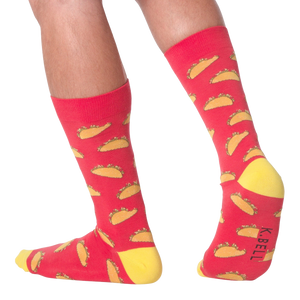 A pair of red socks with a pattern of tacos on them. The socks are pulled up to the wearer's mid-calf.