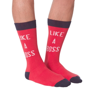 Lifestyle shot: A person's legs wearing the 'Like A Boss' red crew socks with navy cuffs.