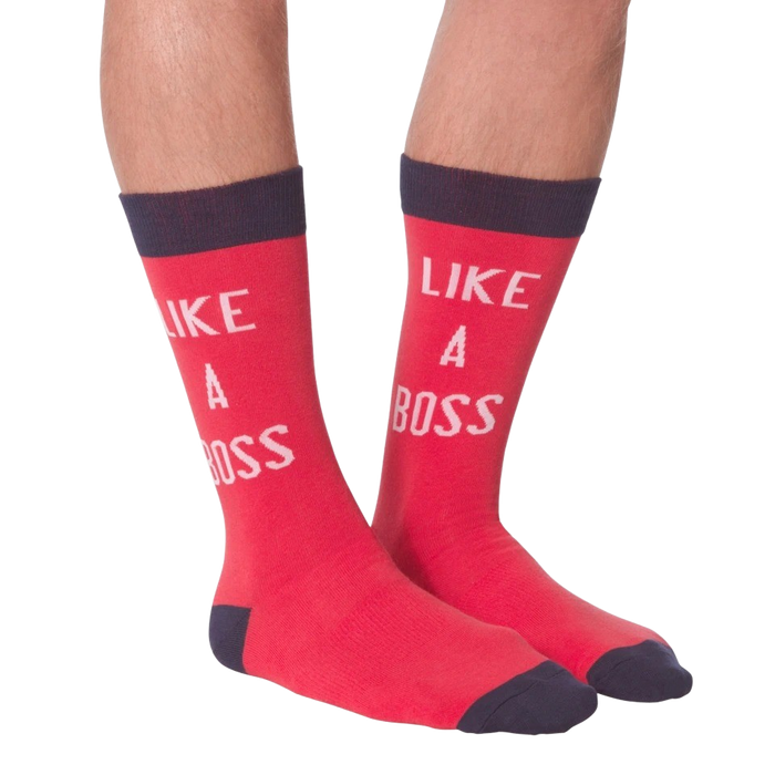 Lifestyle shot: A person's legs wearing the 'Like A Boss' red crew socks with navy cuffs.