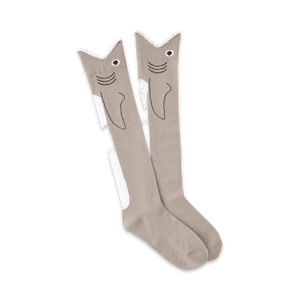 Pair of grey knee-high socks with a whimsical shark face design.  Black outlines and white accents complete the look.