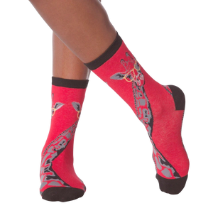 Lifestyle shot of model wearing red crew socks with a giraffe wearing glasses design.
