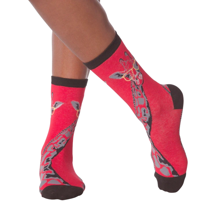 Lifestyle shot of model wearing red crew socks with a giraffe wearing glasses design.
