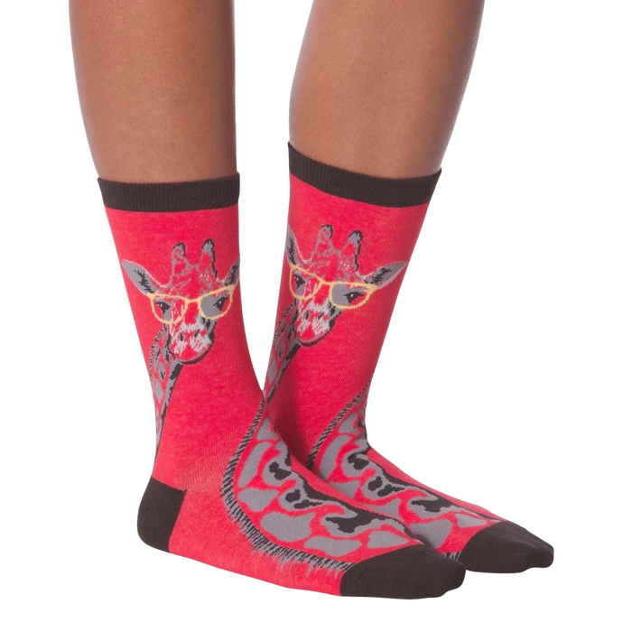 Another lifestyle shot of model wearing red crew socks with a giraffe wearing glasses design.