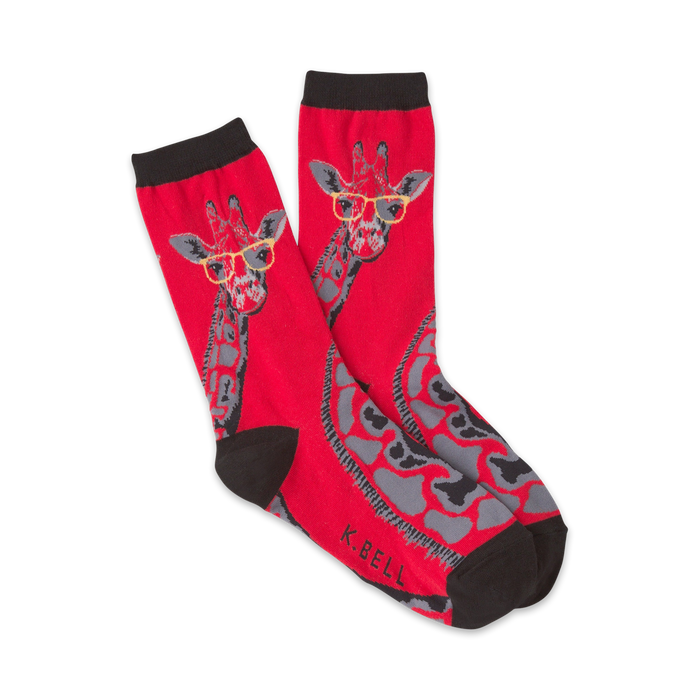 Pair of red crew socks with a whimsical giraffe wearing glasses design. Gray giraffe spots and black cuffs.