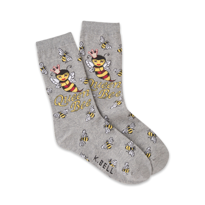 A pair of grey crew socks with a fun design. The main image is a crowned bee with the words 'Queen Bee' repeated throughout. Smaller bees are scattered on the socks as well. }}