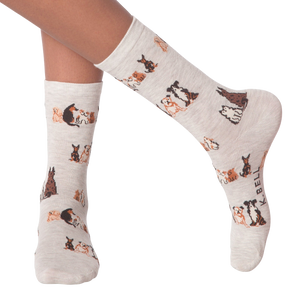 Lifestyle shot of woman's legs wearing the grey crew socks with the dog pattern.