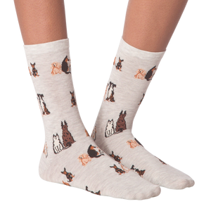 Close-up studio shot of a pair of the grey crew socks; showcasing the dog pattern.