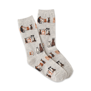 Pair of grey crew socks with a repeating pattern of brown and black illustrated dogs sitting down.