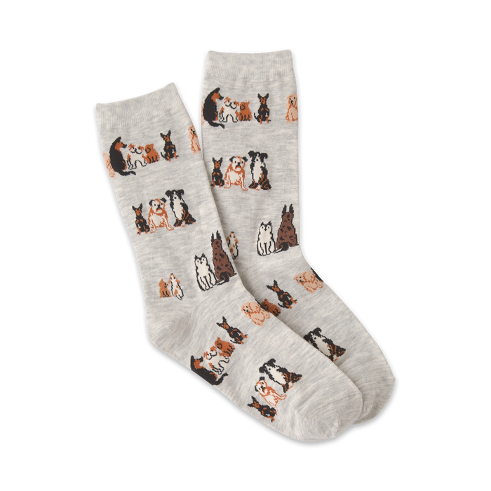 Pair of grey crew socks with a repeating pattern of brown and black illustrated dogs sitting down.