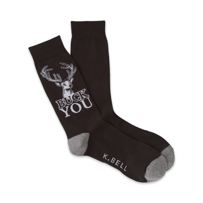 A pair of dark brown crew socks with a white deer graphic and the phrase 'BUCK YOU'. Gray accents at the heel and toe.