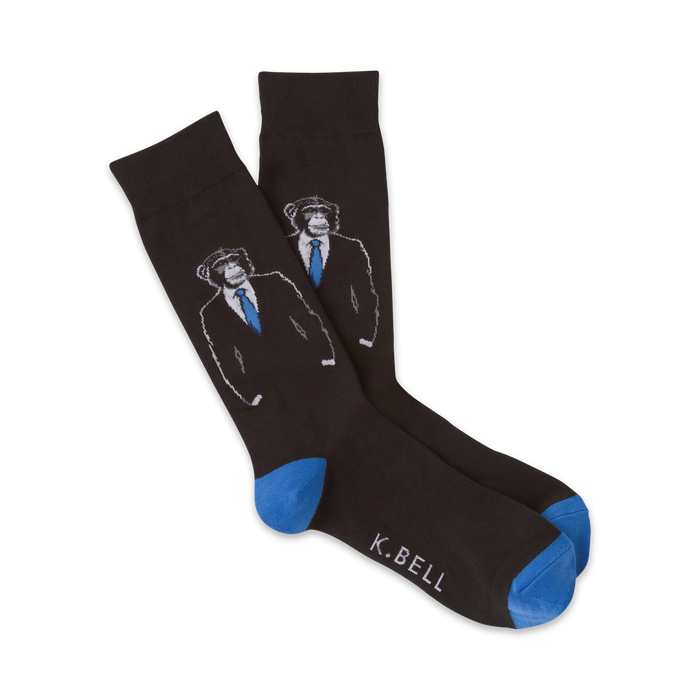 A pair of dark gray crew socks featuring a design of monkeys wearing suits and blue ties. The socks have bright blue cuffs. }}