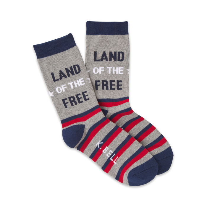 A pair of crew socks in grey, red, and navy blue. The socks feature horizontal stripes and the text 'Land of the Free'. }}