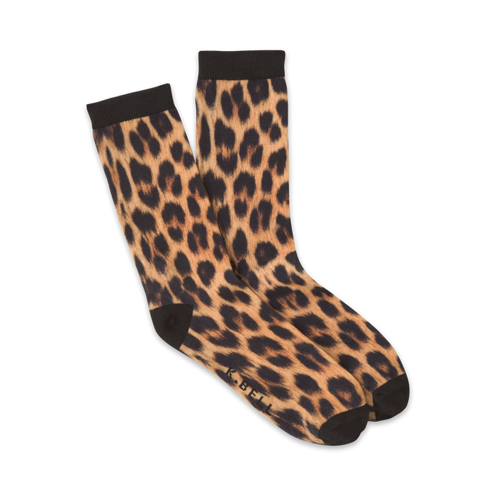 A pair of women's crew socks in a tan and black leopard print. The socks are folded to show both sides of the print. }}