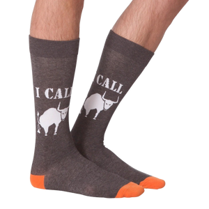 A pair of gray calf-length socks with an orange toe and heel. The socks have the words 