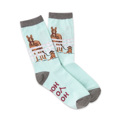 Pair of pastel blue crew socks featuring horses in a fence and a small dog. Gray cuffs and 'Hold Your Horses' text on the sole.
