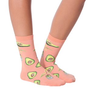 Lifestyle shot of woman's legs wearing peach avocado socks, different pose.