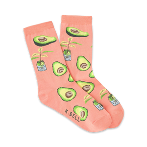 Pair of peach-colored crew socks with illustrated avocados and small potted avocado plants.