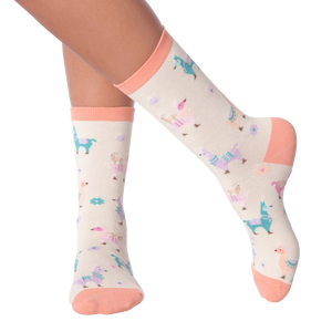 Lifestyle shot showing a person's legs wearing the pastel llama socks.