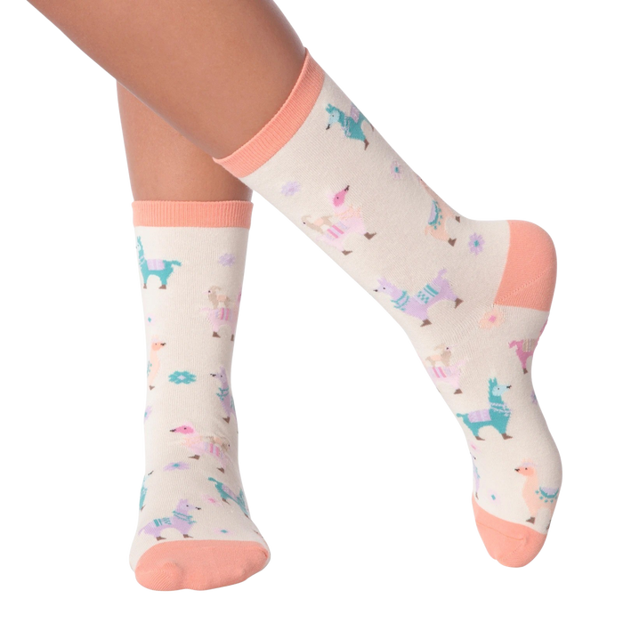 Lifestyle shot showing a person's legs wearing the pastel llama socks.