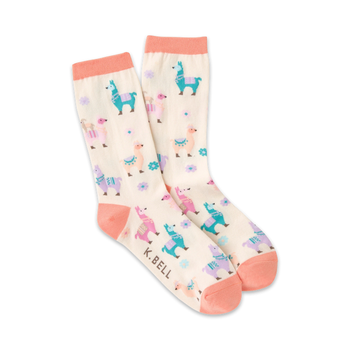 pink crew socks featuring a pattern of multicolored llamas wearing saddles and floral arrangements on a cream-colored background.   