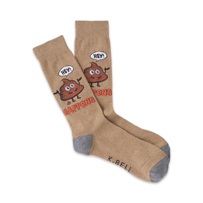 Tan crew socks with a whimsical brown poop emoji design. The emoji says 'Hey!' and the socks read 'Shit Happens'.