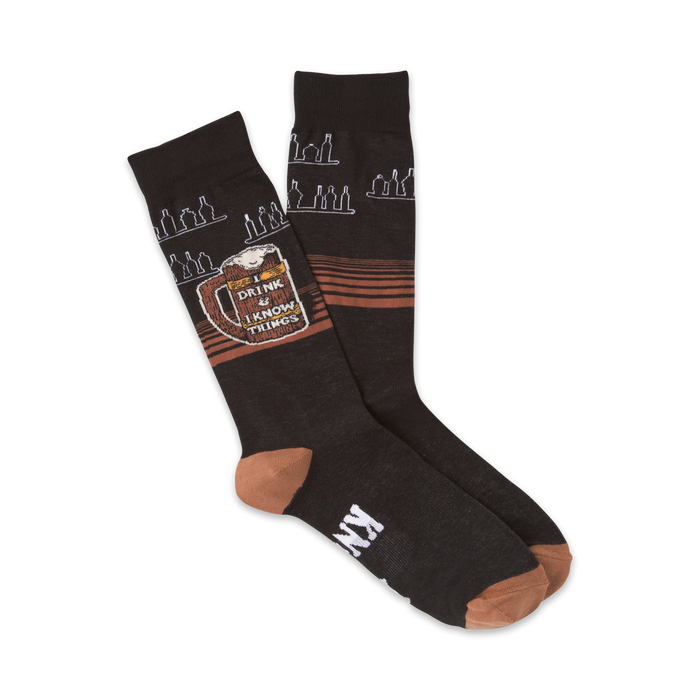 Pair of dark-grey crew socks with a tan heel and toe. Features a beer mug graphic with the text 'I Drink & Know Things' and a repeating bottle design. }}